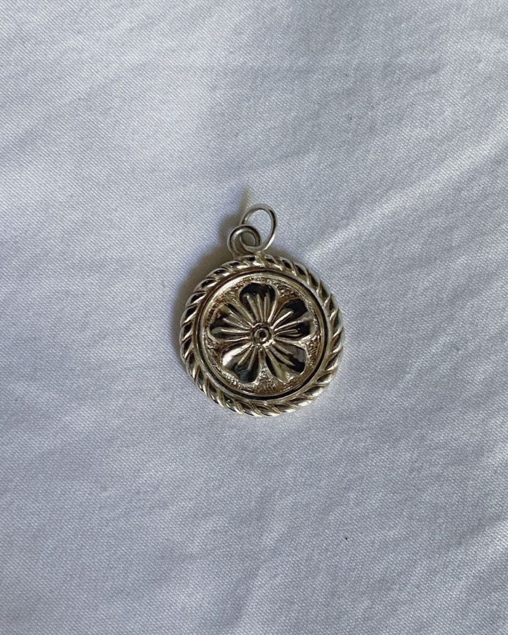Flower coin pendant in 100% certified recycled sterling silver